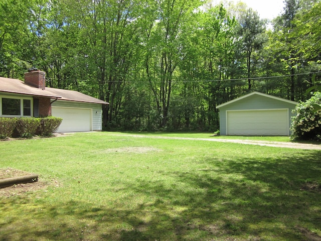 9303 County Road 653, Gobles, MI 49055 - view of green lawn with a detached garage and an outbuilding