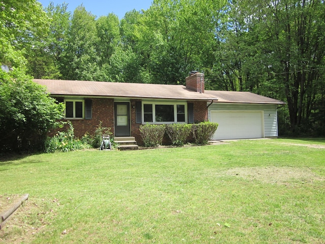 9303 County Road 653, Gobles, MI 49055 - single story home with brick siding, a front yard, and an attached garage