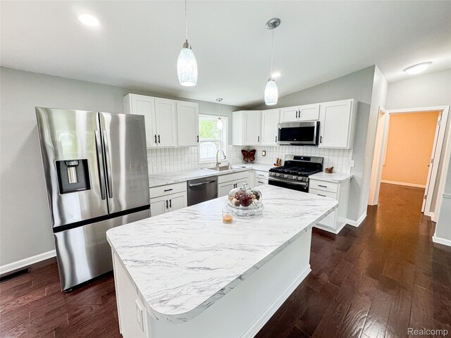 8909 E Country Ln, Lennon, MI 48449 - kitchen featuring appliances with stainless steel finishes, a sink, decorative backsplash, white cabinets, and recessed lighting
