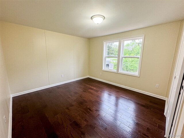 8909 E Country Ln, Lennon, MI 48449 - spare room with dark wood-style flooring and baseboards