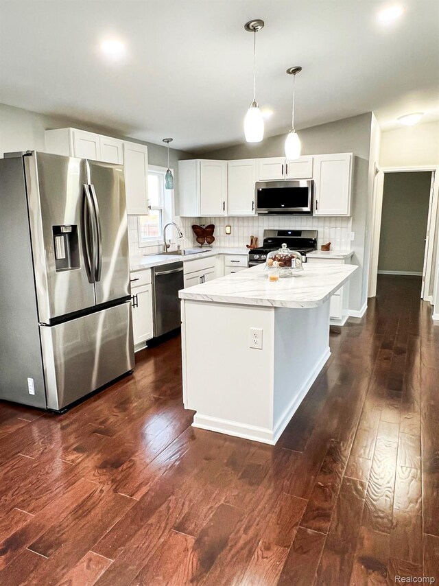 8909 E Country Ln, Lennon, MI 48449 - kitchen with appliances with stainless steel finishes, a sink, dark wood finished floors, backsplash, and white cabinetry