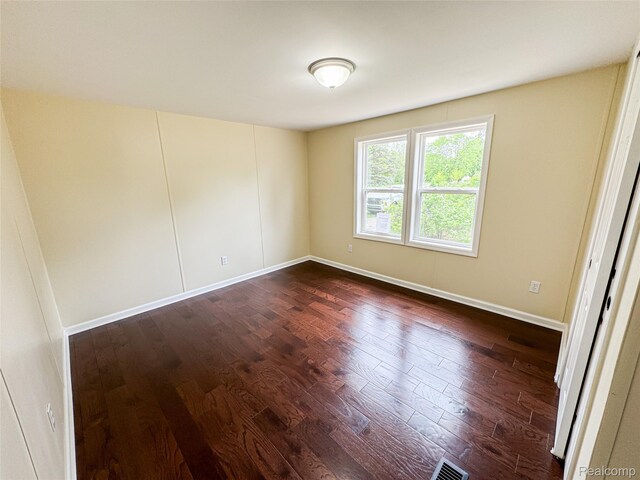 8909 E Country Ln, Lennon, MI 48449 - unfurnished room with dark wood finished floors and baseboards