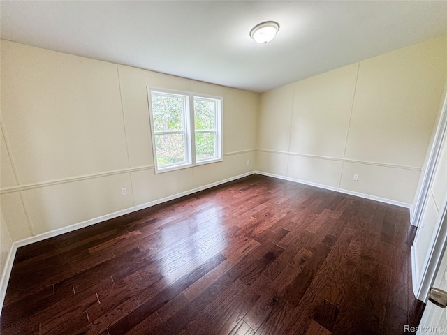 8909 E Country Ln, Lennon, MI 48449 - spare room with dark wood-type flooring and baseboards