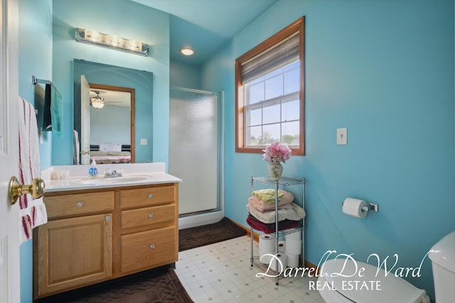 5512 Lillyview Ave SW, Wyoming, MI 49509 - bathroom with toilet, a stall shower, vanity, ceiling fan, and ensuite bath