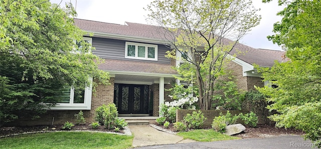 5084 Champlain Cir W, Bloomfield, MI 48323 - view of front of home with a shingled roof, brick siding, french doors, and covered porch