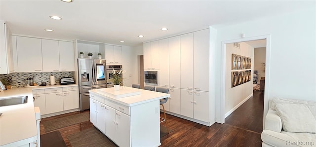 5084 Champlain Cir W, Bloomfield, MI 48323 - kitchen featuring stainless steel appliances, recessed lighting, a center island, tasteful backsplash, and white cabinetry