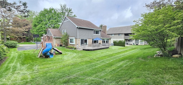 5084 Champlain Cir W, Bloomfield, MI 48323 - rear view of house featuring a playground, a yard, a chimney, and brick siding
