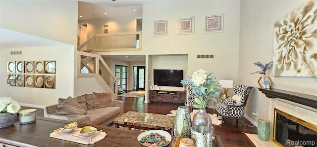5084 Champlain Cir W, Bloomfield, MI 48323 - living area with wood finished floors, baseboards, stairway, a premium fireplace, and a towering ceiling