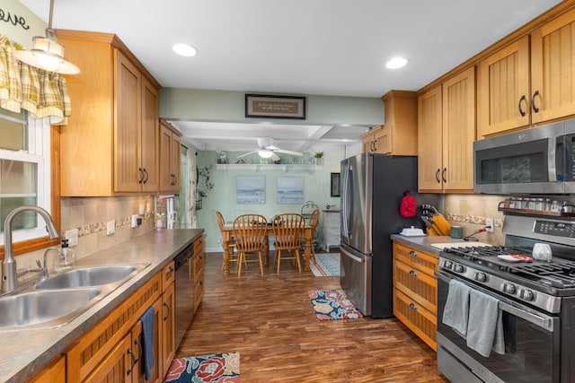 4239 Glen Hollow Dr, Hudsonville, MI 49426 - kitchen featuring appliances with stainless steel finishes, a sink, a ceiling fan, dark wood finished floors, and decorative backsplash