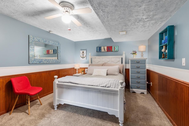 4239 Glen Hollow Dr, Hudsonville, MI 49426 - carpeted bedroom with wainscoting, ceiling fan, and a textured ceiling