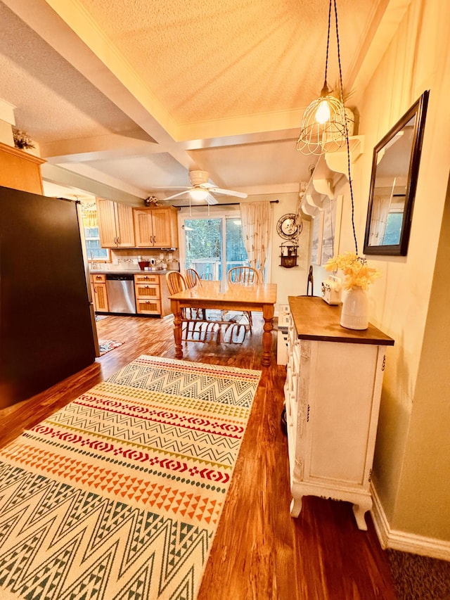 4239 Glen Hollow Dr, Hudsonville, MI 49426 - dining space with wood finished floors, plenty of natural light, beamed ceiling, ceiling fan, and baseboards
