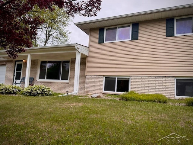 7200 Danny Dr, Saginaw, MI 48609 - back of property with a yard and brick siding