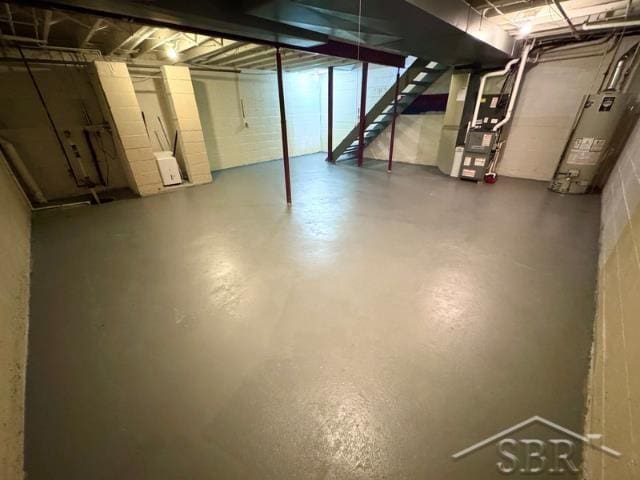 7200 Danny Dr, Saginaw, MI 48609 - below grade area featuring gas water heater, stairway, and heating unit