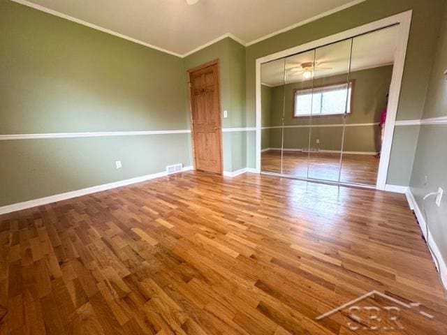 7200 Danny Dr, Saginaw, MI 48609 - unfurnished bedroom featuring wood finished floors, ornamental molding, baseboards, and a closet