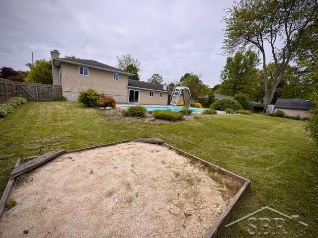 7200 Danny Dr, Saginaw, MI 48609 - rear view of property with a chimney
