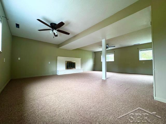 7200 Danny Dr, Saginaw, MI 48609 - below grade area featuring ceiling fan, carpet, baseboards, and a brick fireplace