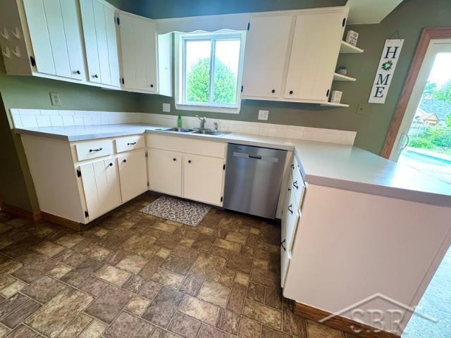 7200 Danny Dr, Saginaw, MI 48609 - kitchen featuring stainless steel dishwasher, plenty of natural light, a sink, and light countertops