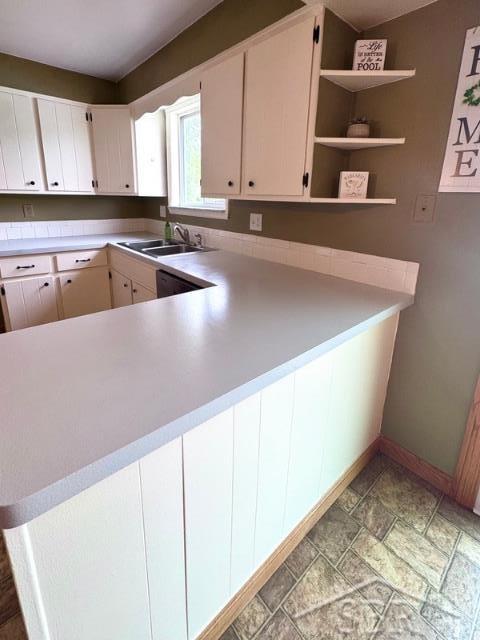 7200 Danny Dr, Saginaw, MI 48609 - kitchen with baseboards, a sink, light countertops, light stone finish floors, and open shelves