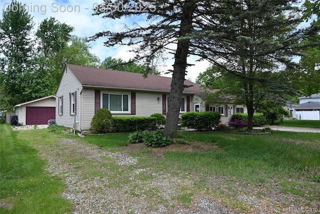 23744 Liddle St, Brownstown, MI 48183 - view of front of home featuring a detached garage, a front yard, and roof with shingles
