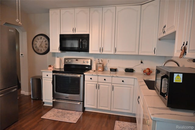 23744 Liddle St, Brownstown, MI 48183 - kitchen featuring appliances with stainless steel finishes, dark wood-style floors, and white cabinetry