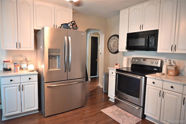 23744 Liddle St, Brownstown, MI 48183 - kitchen with stainless steel appliances, arched walkways, white cabinets, and light countertops