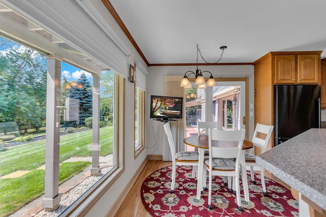 1780 Williamsburg Dr, Adrian, MI 49221 - dining area featuring light wood finished floors, a chandelier, ornamental molding, and baseboards