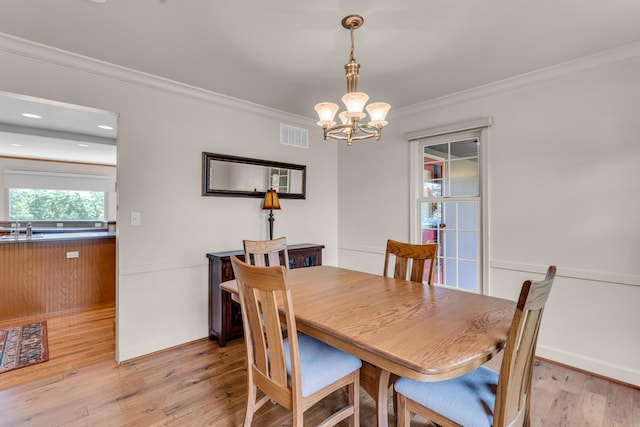 1780 Williamsburg Dr, Adrian, MI 49221 - dining space with a chandelier, crown molding, and light wood finished floors