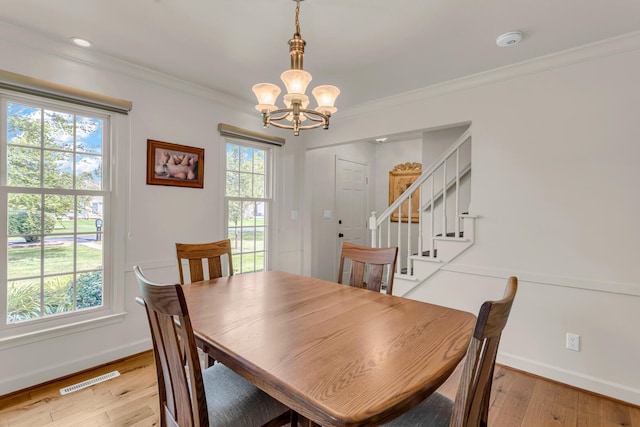 1780 Williamsburg Dr, Adrian, MI 49221 - dining room with a chandelier, baseboards, stairway, light wood-type flooring, and crown molding
