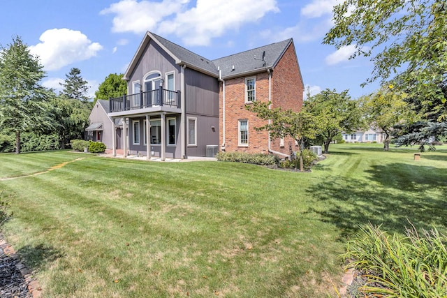 1780 Williamsburg Dr, Adrian, MI 49221 - rear view of property with brick siding, a yard, a patio area, a balcony, and central AC unit