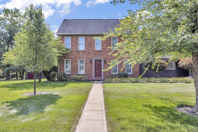 1780 Williamsburg Dr, Adrian, MI 49221 - view of front of property with a front yard, brick siding, and roof with shingles