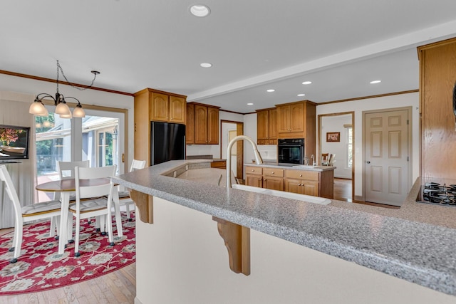 1780 Williamsburg Dr, Adrian, MI 49221 - kitchen featuring black appliances, crown molding, light countertops, recessed lighting, and light wood-type flooring