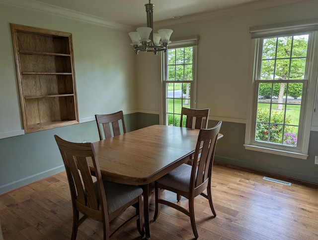 1780 Williamsburg Dr, Adrian, MI 49221 - dining room with a chandelier, crown molding, light wood finished floors, and baseboards
