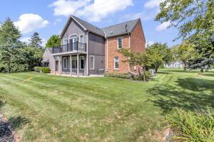 1780 Williamsburg Dr, Adrian, MI 49221 - rear view of property with a balcony and a lawn