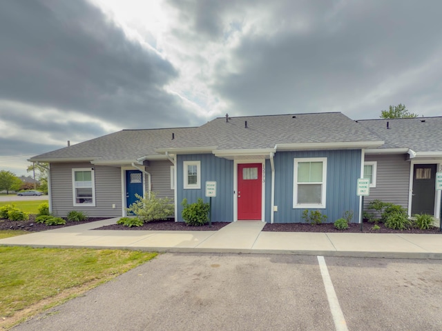12773 Felch St, Holland, MI 49424 - view of property featuring board and batten siding, roof with shingles, and uncovered parking