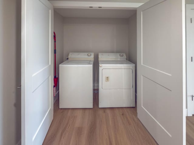12773 Felch St, Holland, MI 49424 - laundry room featuring washer and dryer and light wood finished floors