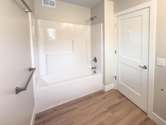 12773 Felch St, Holland, MI 49424 - full bath featuring shower / washtub combination, wood finished floors, and baseboards