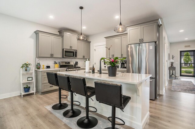 6617 Sheldon Crossing Dr, Hudsonville, MI 49426 - kitchen featuring stainless steel appliances, gray cabinets, light wood-style flooring, and recessed lighting