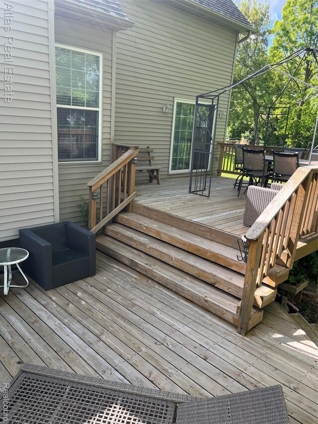 4440 Colby Ct, Burton, MI 48519 - wooden deck with outdoor dining area
