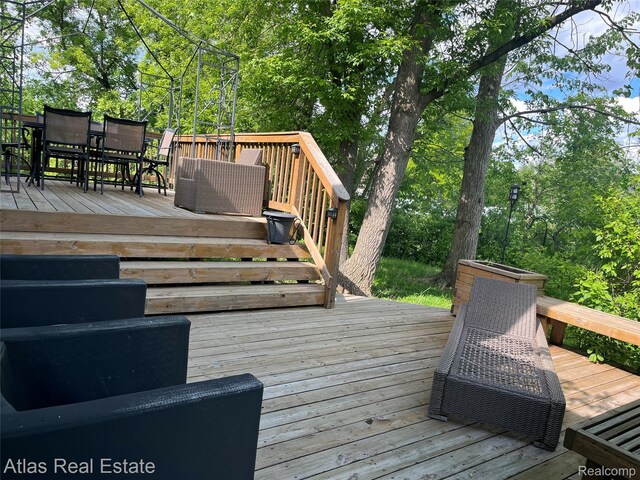 4440 Colby Ct, Burton, MI 48519 - wooden terrace with outdoor dining area and view of scattered trees