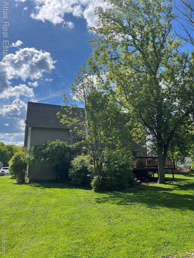 4440 Colby Ct, Burton, MI 48519 - view of grassy yard featuring a deck