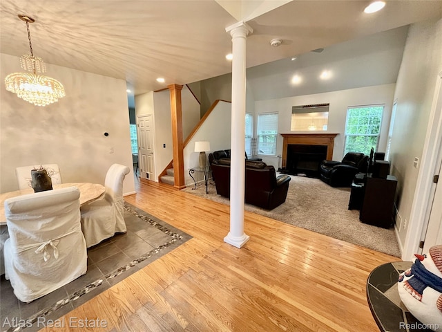 4440 Colby Ct, Burton, MI 48519 - living room with ornate columns, stairway, a fireplace, wood finished floors, and recessed lighting
