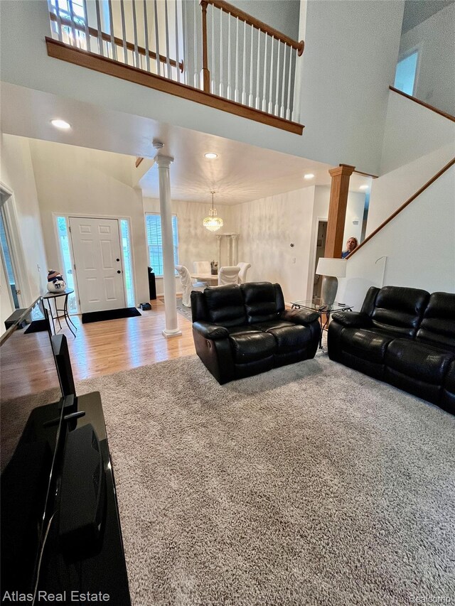 4440 Colby Ct, Burton, MI 48519 - living room featuring decorative columns, a towering ceiling, wood finished floors, and recessed lighting