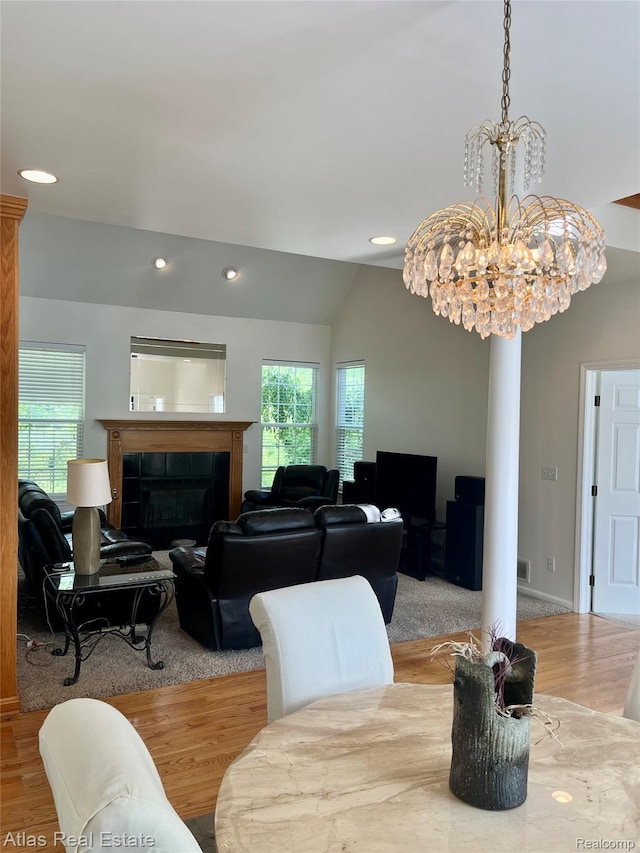 4440 Colby Ct, Burton, MI 48519 - dining space with wood finished floors, plenty of natural light, a fireplace, recessed lighting, and a chandelier