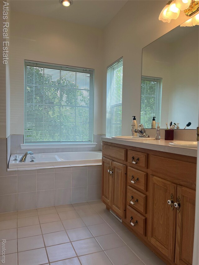 4440 Colby Ct, Burton, MI 48519 - bathroom featuring a garden tub, vanity, and tile patterned flooring