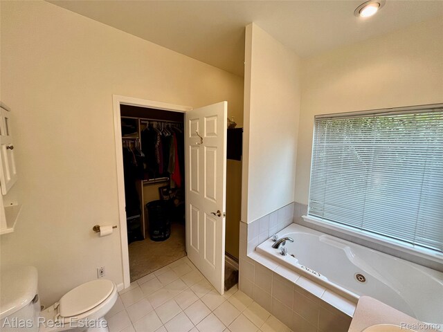 4440 Colby Ct, Burton, MI 48519 - bathroom featuring a whirlpool tub, tile patterned flooring, toilet, and a spacious closet