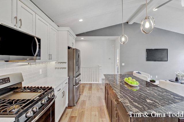 903 S Center Park Dr SW Unit 14, Byron Center, MI 49315 - kitchen with stainless steel appliances, light wood-type flooring, decorative backsplash, dark stone counters, and white cabinetry