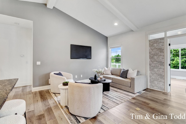 903 S Center Park Dr SW Unit 14, Byron Center, MI 49315 - living room with beamed ceiling, light wood finished floors, baseboards, and high vaulted ceiling