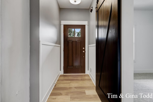 903 S Center Park Dr SW Unit 14, Byron Center, MI 49315 - doorway featuring a barn door, wainscoting, and light wood-style floors
