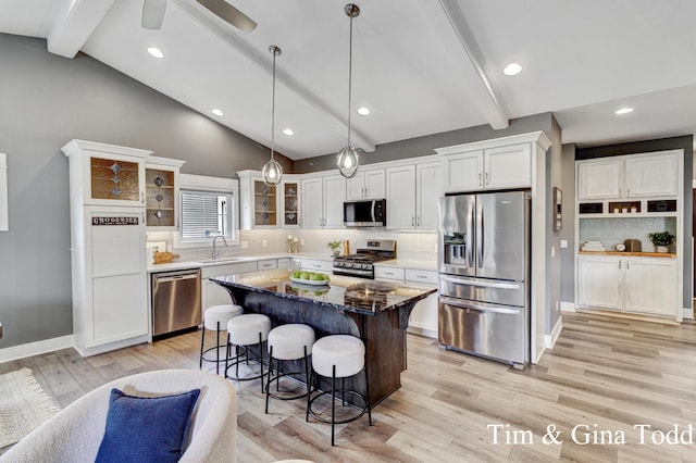903 S Center Park Dr SW Unit 14, Byron Center, MI 49315 - kitchen with appliances with stainless steel finishes, a kitchen bar, glass insert cabinets, decorative backsplash, and white cabinets