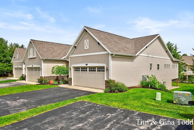 903 S Center Park Dr SW Unit 14, Byron Center, MI 49315 - view of front of home featuring a shingled roof, a front yard, driveway, and stone siding